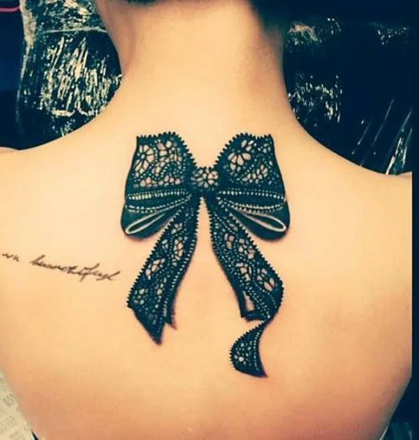 Thigh lace tattoo with a bow and long stripes
