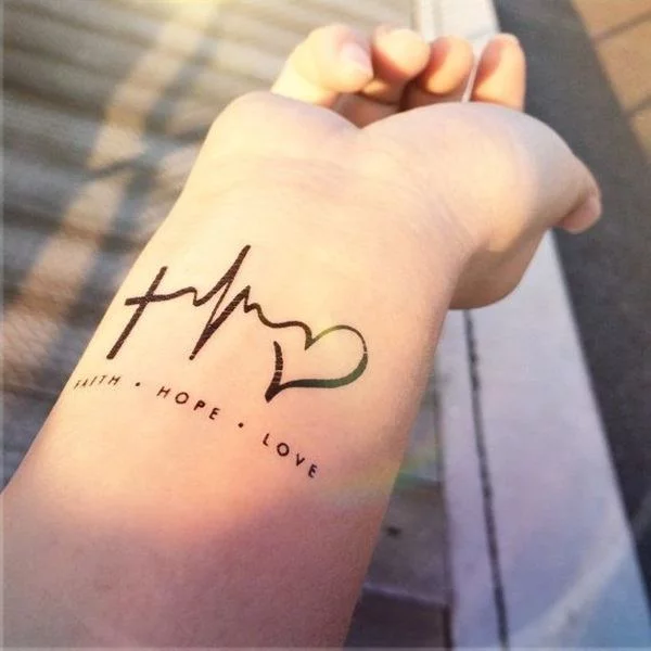 Tattoo of the word love handwritten on the wrist