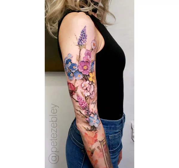 Abstract style sleeve tattoo that includes geometric