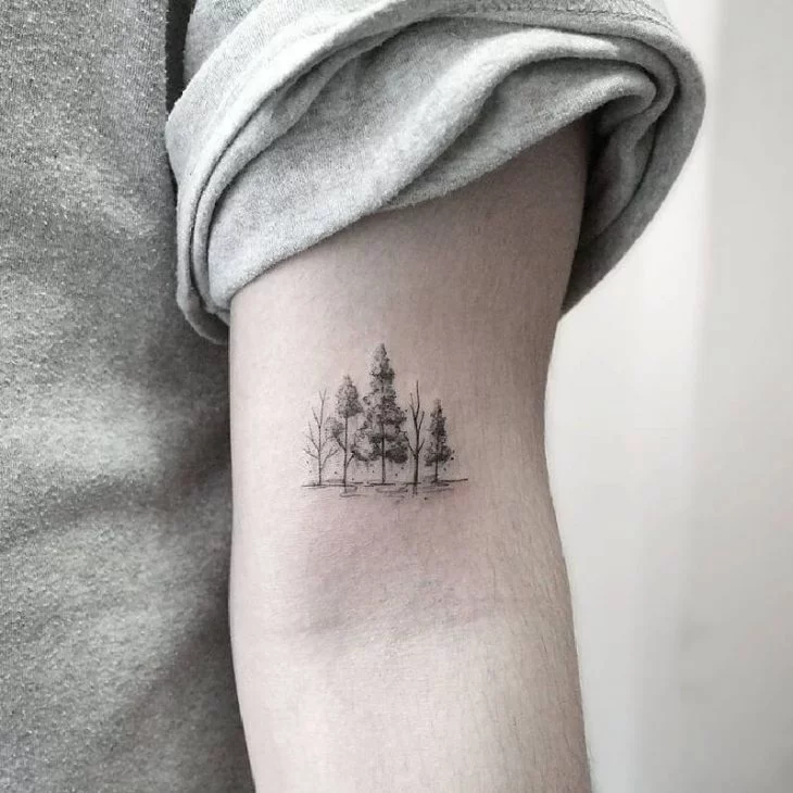 Fine line pine tree tattoo on the inner forearm